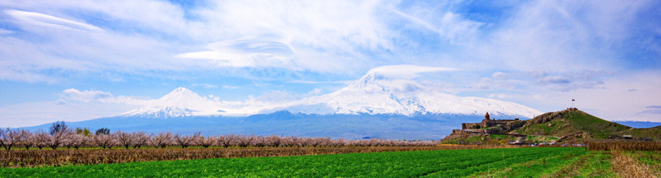 Panoramic view of majestic peaks over cultivated farmland. Khor Virap is an Armenian monastery