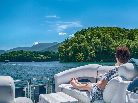 Woman sitting in a pontoon boat from behind