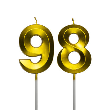A pair of shiny golden birthday candles in the shape of the number ninety eight, featuring a spiral textured surface and isolated on a plain white background.