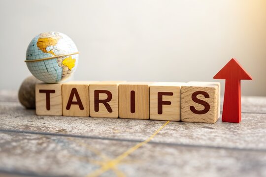 Wooden blocks spelling 'TARIFS' with a globe and an upward arrow, symbolizing global trade changes