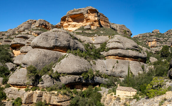 The Romanesque hermitage of Sant Bartomeu de Fraguerau, built in the 13th century, is located in a ravine within the Montsant mountain range, Tarragona province, Catalonia, Spain.