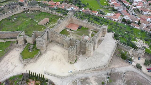 Aerial view of Trujillo Castle ruins in Caceres, Spain. Historic hilltop fortress remains open to visitors, medieval stone structures overlooking Castilla La Mancha landscape.