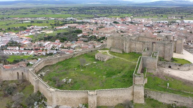 Aerial view of Trujillo Castle ruins in Caceres, Spain. Historic hilltop fortress remains open to visitors, medieval stone structures overlooking Castilla La Mancha landscape.