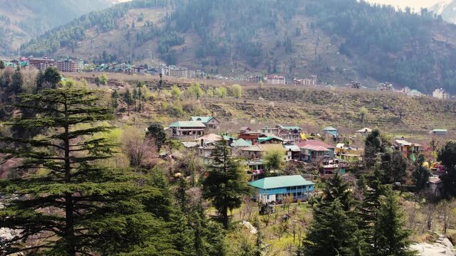 Houses on mountain slopes representing remote living, peaceful lifestyle and connection with nature in rural high altitude environment.