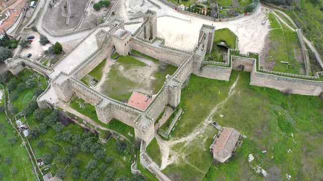 Aerial view of Trujillo Castle ruins in Caceres, Spain. Historic hilltop fortress remains open to visitors, medieval stone structures overlooking Castilla La Mancha landscape.