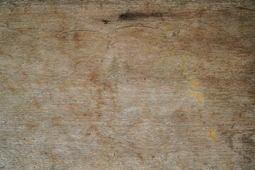 Fototapeta premium Close-up of weathered wooden surface showing natural grain patterns knots and subtle discoloration with a warm earthy tone suitable for rustic or vintage design projects