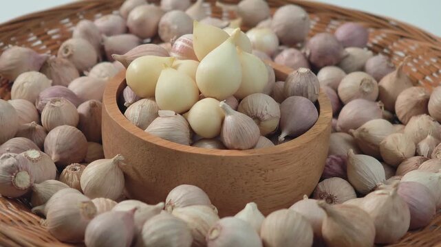 Single clove garlic in a wooden cup.