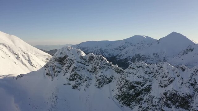 Snowy winter mountains with alpine landscape and clear sky