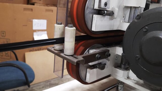 The industrial line puller pulling the plastic pipe wire hose