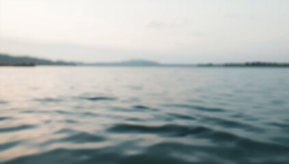 Obraz premium Calm Water Body with Gentle Waves Under Overcast Sky in Natural Outdoor Setting