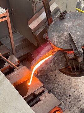 Melted metal pouring in to the sand mold in die casting process