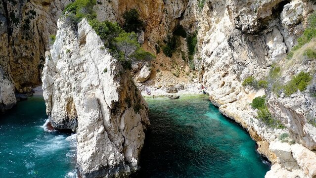 Aerial view of the beautiful and hidden  Cala En Cal&oacute;, and the anchorage in Cape La Nao, coast of the town of J&aacute;vea, Mediterranean Sea, Spain.