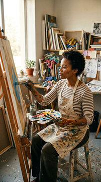 Female Artist Painting on Canvas in Art Studio