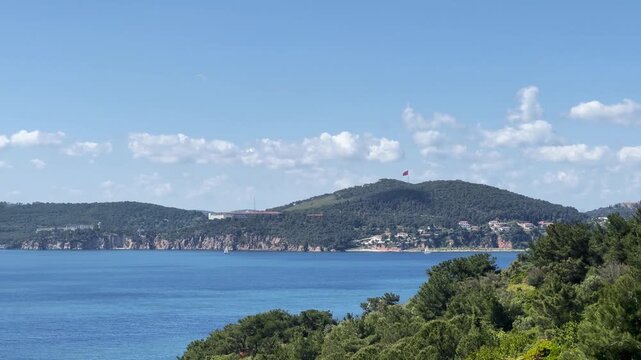 Panoramic view of Heybeliada from B&uuml;y&uuml;kada, capturing serene, coast atmosphere, natural life and green vegetation of Istanbul Prince Islands