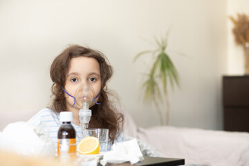Sick child breathes in a nebulizer inhaler. Kid makes inhalation, looking thoughtful and unwell.
