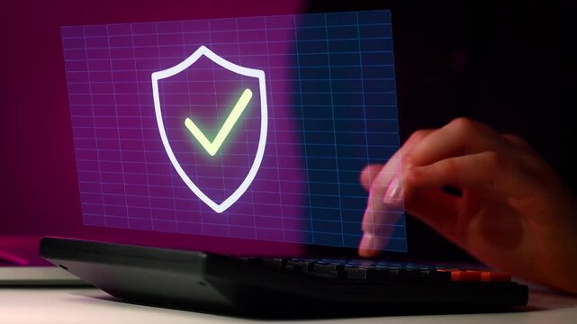 Person using a laptop with a digital security icon showing a shield and check mark.