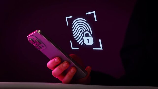 Using a smartphone for fingerprint authentication in a dark setting at night.