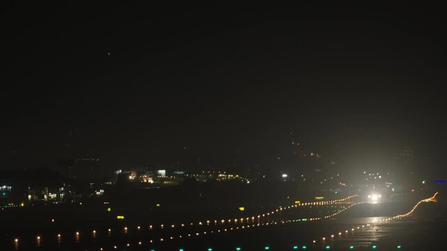 Large passenger jet lifting off from the runway into the dark sky at Valencia airport in Spain