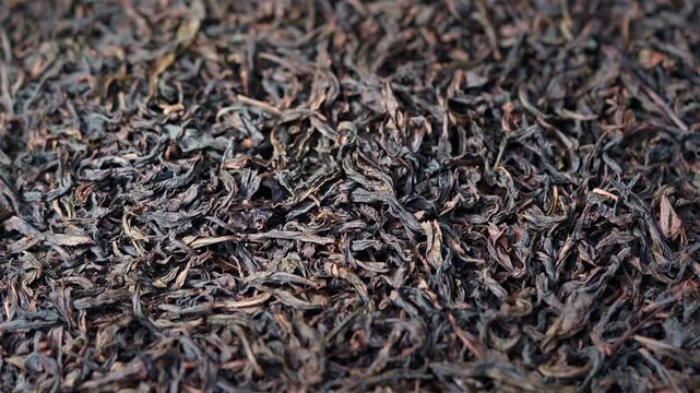 Macro Close-up of Premium Dried Black Tea Leaves with Rising Steam and Aroma for Traditional Tea Culture Commercial Ads