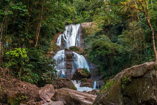 Bayoz waterfall in Oxapampa Peru surrounded by tropical rainforest flowing over rocky mountain landscape for travel tourism adventure and ecotourism