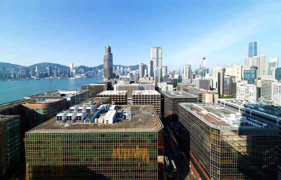 Aerial scenery of Hong Kong, viewed from Tsim Sha Tsui in Kowloon, with a city skyline of crowded skyscrapers by Victoria Harbour under blue clear sky ~ Beautiful cityscape of Hongkong on a sunny day