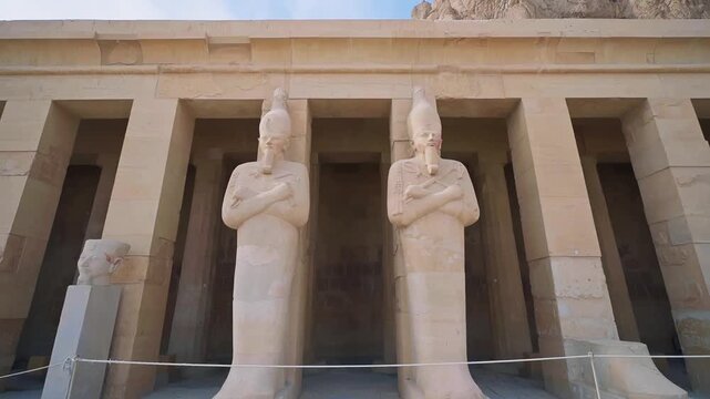 Queen Hatshepsut Temple in Valley of the Kings, Sculptures of Pharaohs at the entrance on floor three of Hatshepsut's Funerary Temple in Luxor, Egypt.Ancient Egyptian wall paintings