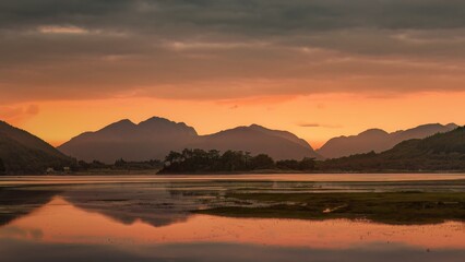 Fototapeta premium Early morning autumn sunrise across Loch Leven in Glencoe, Scotland, UK