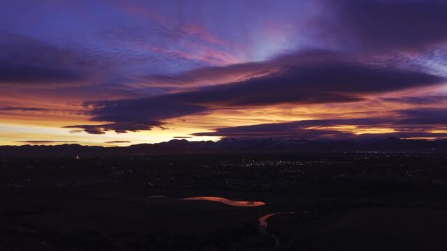 Dramatic purple sunset over mountains and city in Midvale, Utah, USA