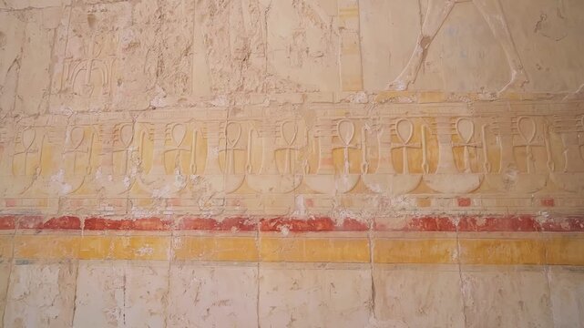 Queen Hatshepsut Temple in Valley of the Kings, Sculptures of Pharaohs at the entrance on floor three of Hatshepsut's Funerary Temple in Luxor, Egypt.Ancient Egyptian wall paintings