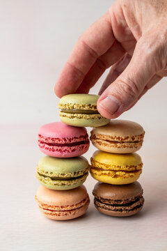 Stack of multi colored macaroons on a light surface 