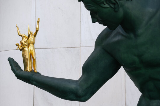 Detroit, Michigan, March 7, 2022: Detail of the historic Spirit of Detroit bronze sculpture at the Coleman A. Young Municipal Center, showing the gilded family group held in its outstretched hand