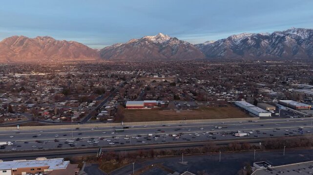 Aerial view of I-15 highway and alpenglow on Wasatch Mountains in Midvale Utah