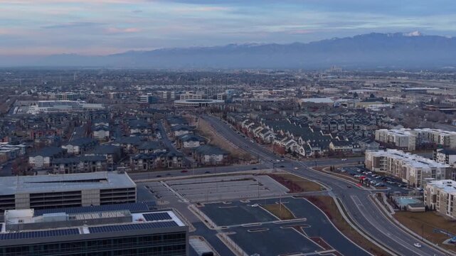 Aerial view of city street and mountains at dusk in Midvale Utah