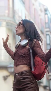 Happy female traveler dancing in the streets of Madrid