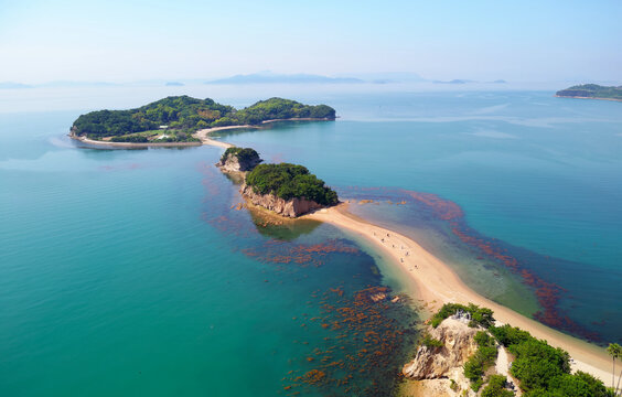 Aerial view of the Angel Road under blue sunny sky, a tidal sandbar connecting 3 beautiful offshore islets to Shodoshima Island in Seto Inland Sea and a tourist attraction in Tonosho, Kagawa, japan