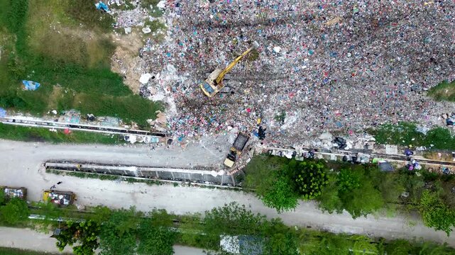 Aerial landfill representing overconsumption and waste crisis linked to global consumer behavior and economy