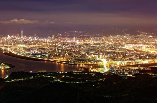 From Yinghan Peak, Taipei glows&mdash;Tamsui River shimmers, Taipei 101 pierces the skyline, and the city radiates like a constellation woven between mountain shadows and urban brilliance
