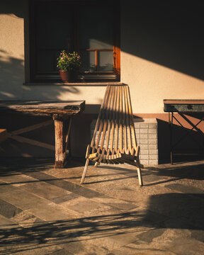 Wooden chair on a sunny terrace in warm golden light