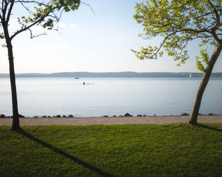 Calm spring view of Lake Balaton framed by trees