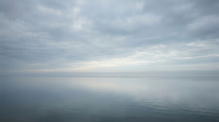 Obraz premium Serene Seascape Photo with Calm Water and Cloudy Sky in Natural Environment