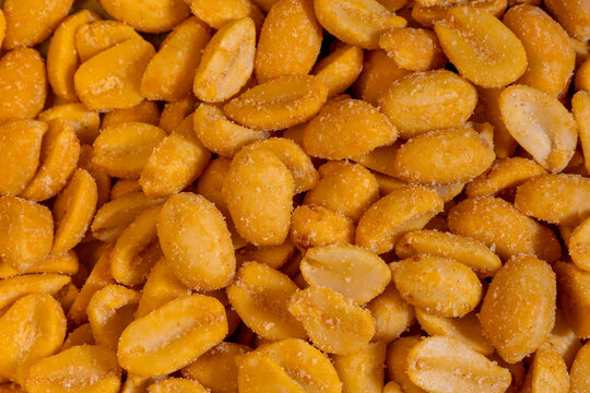 Roasted salted peanuts macro texture snack food closeup detail