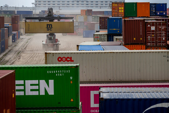 Warsaw, Poland - April 04, 2026: Container reach stacker handling intermodal shipping containers at the Loconi terminal in Warsaw Torunska
