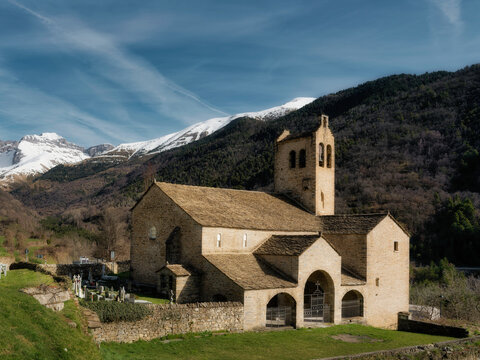 Romanesque church in the Aragonese Pyrenees with snow-capped mountains