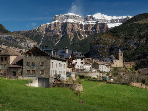 Village in the Aragonese Pyrenees with snow-capped mountains in the background