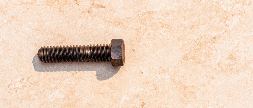 Metal bolt screw fastener hardware threaded close up detail construction tool iron steel mechanical industrial object isolated single shadow texture surface brown rusty macro equipment repair