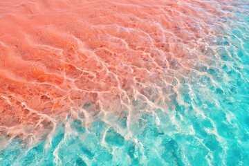 Fototapeta premium Turquoise water meeting pink sand shoreline with visible ripples