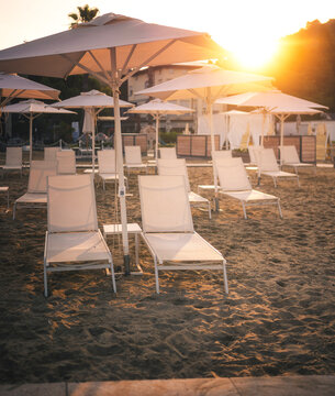 Seaside promenade with loungers in Portorož at sunrise