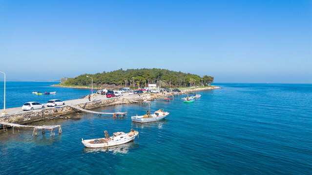 Izmir - Turkey, June 10, 2025, Aerial view of the historic Quarantine Island connected by a narrow road in Urla, Izmir, Turkey.