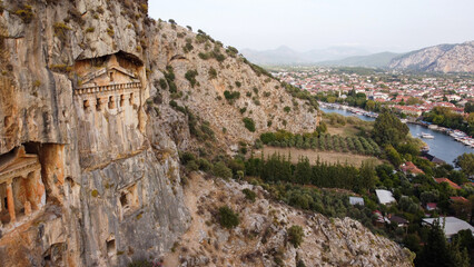 Fototapeta premium Aerial View of Ancient Lycian King Rock Tombs Carved into High Cliffs in Dalyan Kaunos Turkey