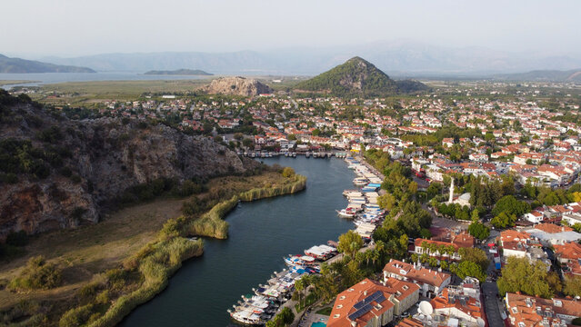 Aerial High Angle View of Dalyan River Canal and Town with Mountains and Boats in Mugla Turkey